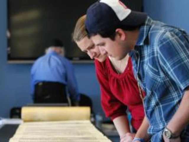 Students looking at a Torah scroll.