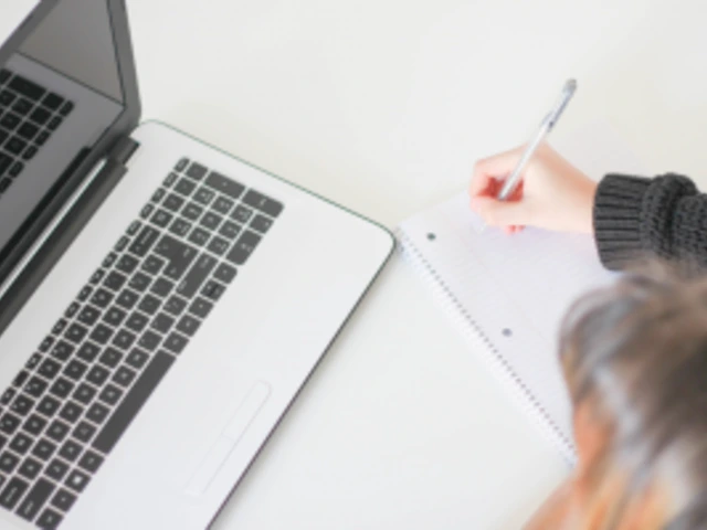 Person writing while on the phone