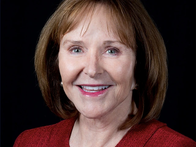 Woman in short brown hair wearing red smiles for the camera