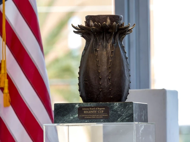 A Regents' Cup award in bronze, stands on a marble pedestal with an American flag to the left