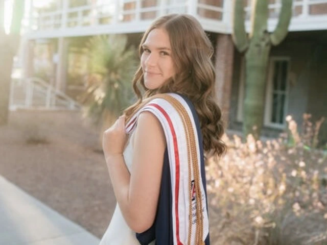 Student with long light brown hair and wearing graduation regalia stands outside in front of a cactus
