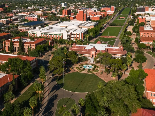 Aerial view of college campus with many red brick buildings and trees