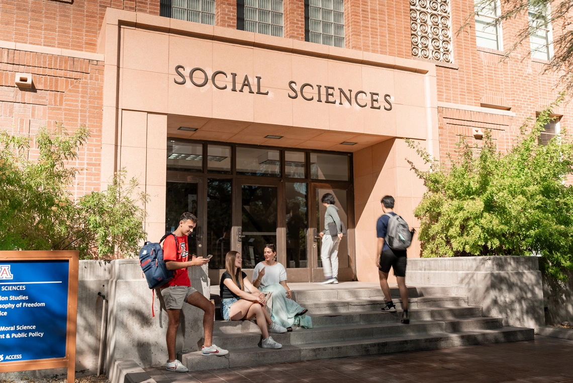 four students in front of the Social Sciences building