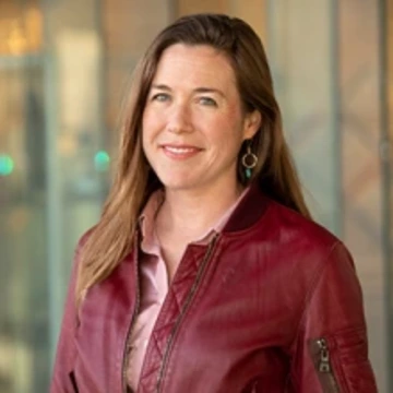 Woman with long blonde hair wearing a red leather jacket