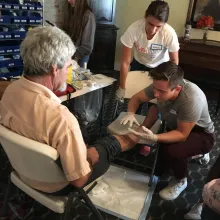 Two students assessing a knee injury