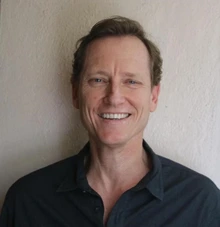 Man with blonde hair and wearing black shirt