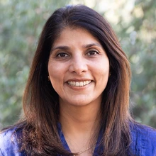 Woman with dark brown hair and blue shirt