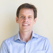 Man with blonde hair and blue shirt