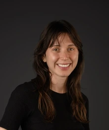 Woman wearing a black shirt in a black background