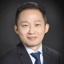 Man in a dark suit with a dark blue tie