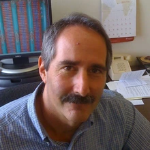 man with dark hair and mustache