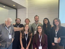 Tom Bever stands with a group of seven students, all wearing lanyards